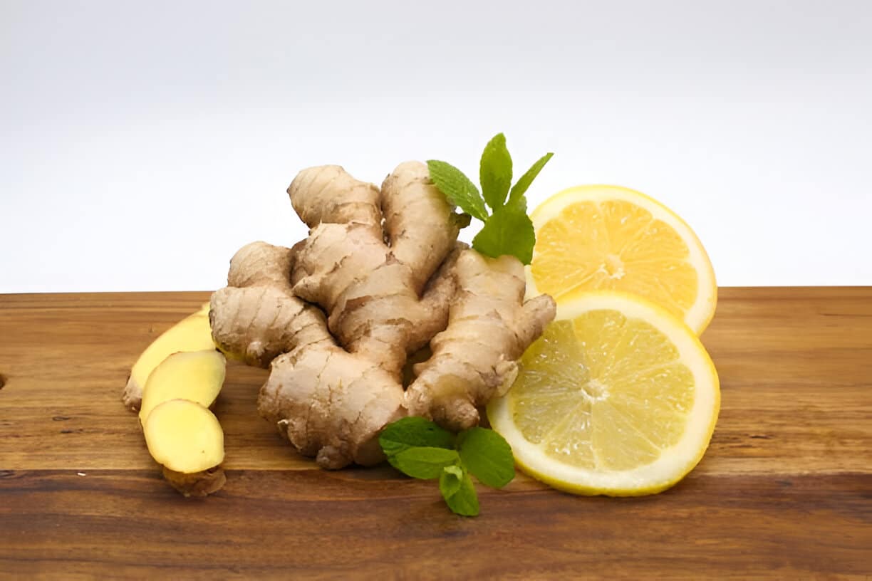 Ingrédients naturels : gingembre et citron Gingembre frais et tranches de citron sur planche en bois